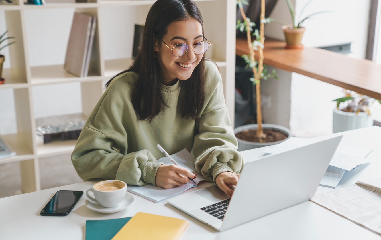 happy teen smiling working on laptop