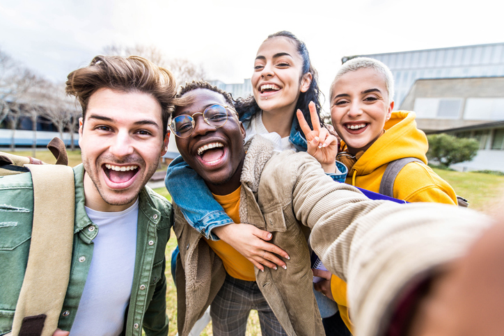 group of teens smiling for a selfie